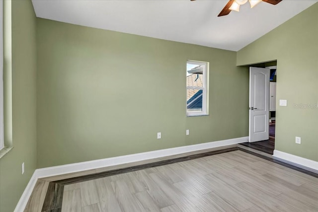 spare room with light hardwood / wood-style floors, lofted ceiling, and ceiling fan