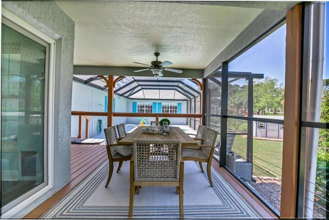 sunroom featuring ceiling fan and plenty of natural light