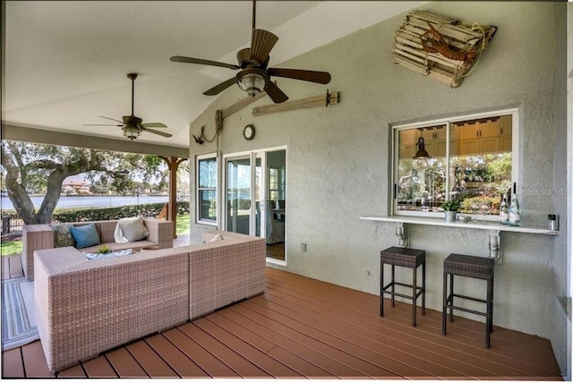 wooden deck with an outdoor hangout area and ceiling fan