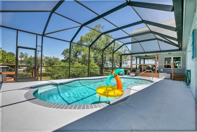 view of swimming pool with a patio area, a lanai, and ceiling fan