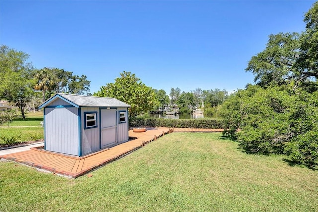 view of yard with a water view and a shed