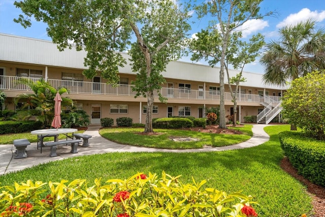 view of home's community with a patio area and a yard