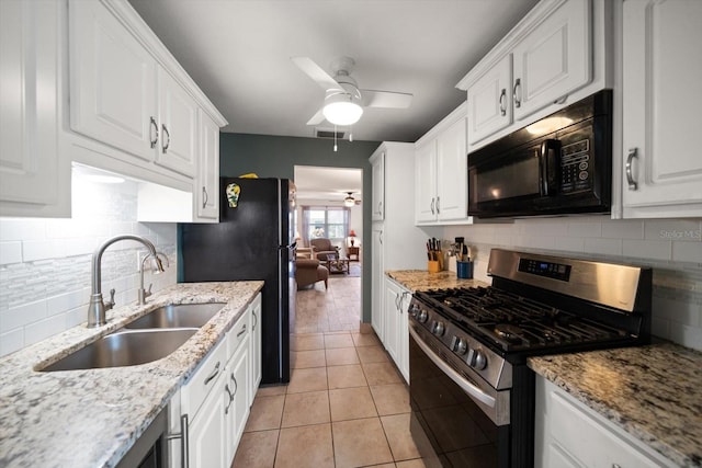 kitchen with ceiling fan, black appliances, tasteful backsplash, white cabinetry, and sink