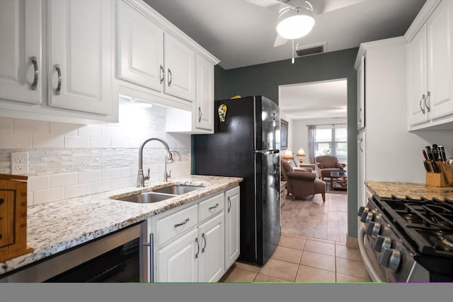 kitchen featuring white cabinetry, ceiling fan, and sink