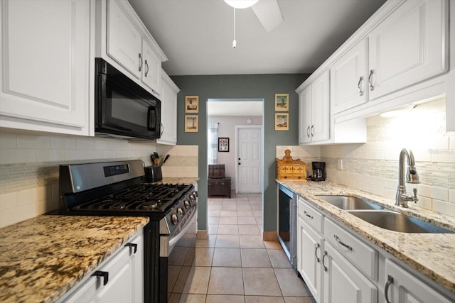 kitchen with backsplash, stainless steel range with gas stovetop, and white cabinets