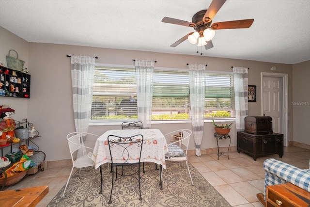 tiled dining space featuring a wealth of natural light and ceiling fan