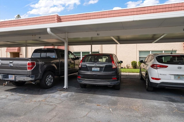 view of parking / parking lot featuring a carport