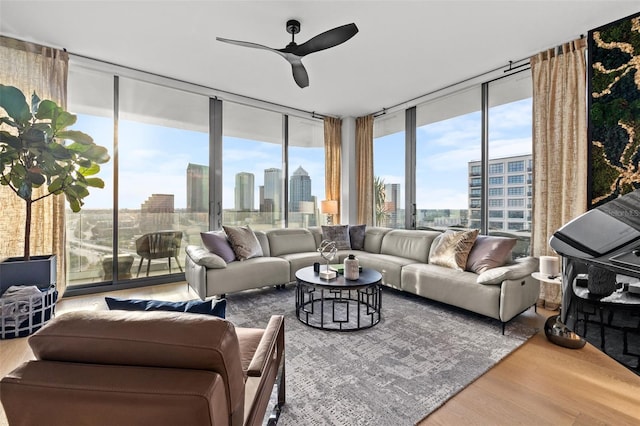 living room with hardwood / wood-style floors, floor to ceiling windows, and ceiling fan