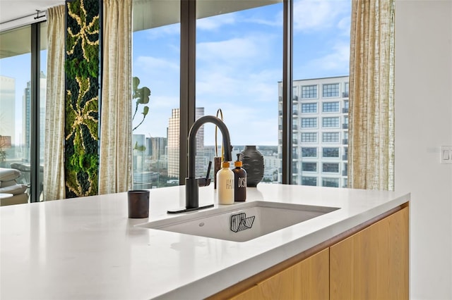 kitchen with light brown cabinetry and sink