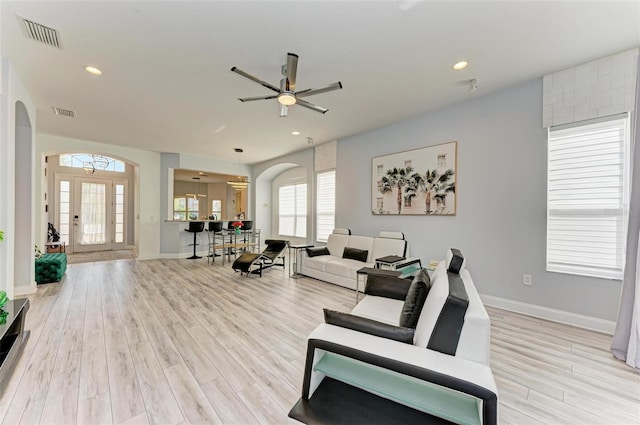 living room with ceiling fan and light wood-type flooring