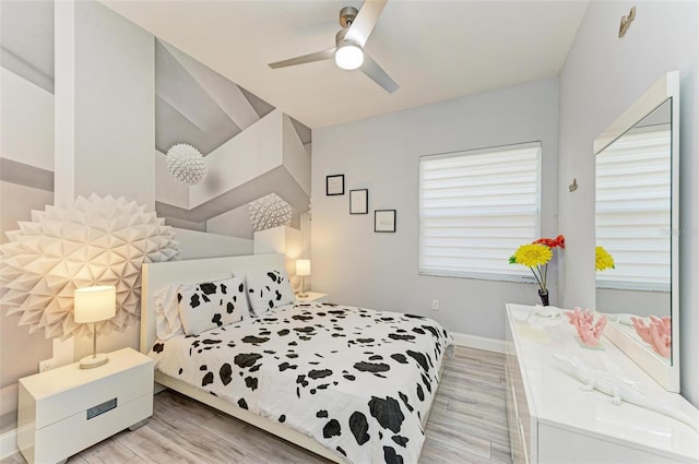 bedroom with light hardwood / wood-style flooring and ceiling fan