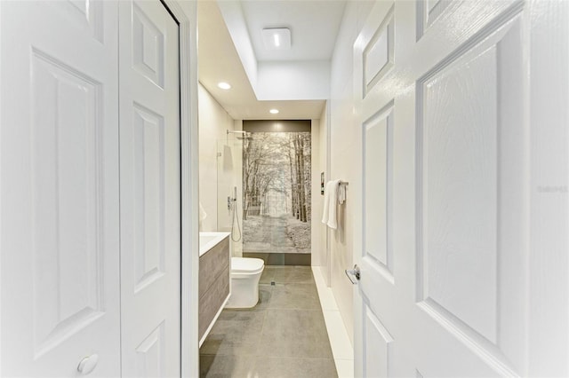 bathroom with tile flooring, vanity, and toilet