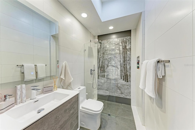 bathroom featuring walk in shower, a skylight, toilet, and tile walls