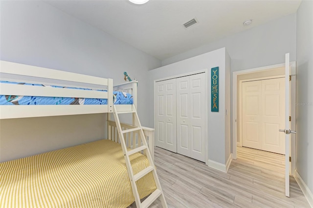 bedroom featuring a closet and light wood-type flooring