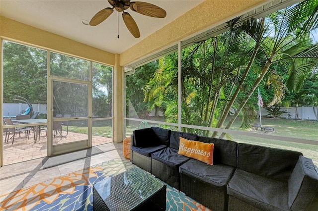 sunroom / solarium featuring ceiling fan