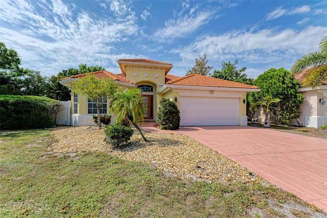 mediterranean / spanish home with a garage and central air condition unit