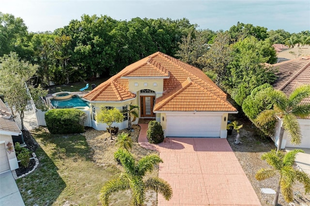 mediterranean / spanish house with a garage