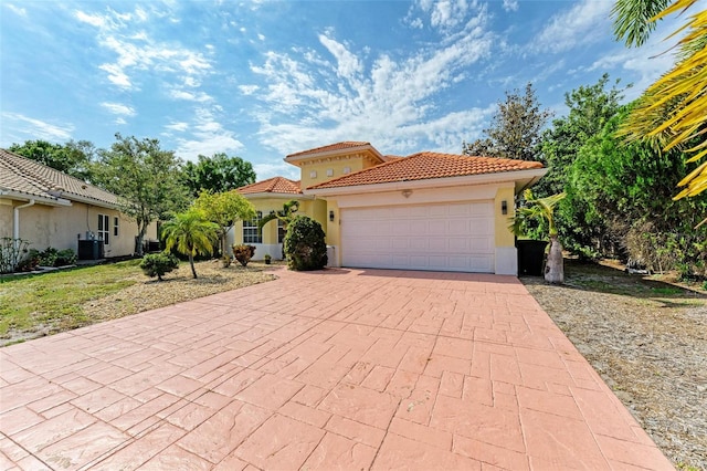 mediterranean / spanish-style home with a garage