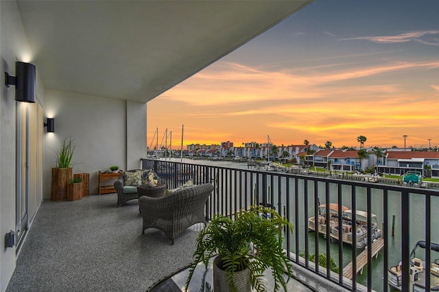 balcony featuring a residential view and a water view