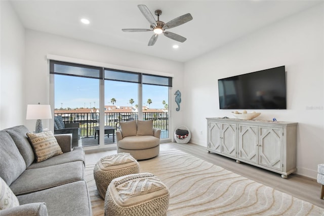 living area with recessed lighting, baseboards, and light wood finished floors