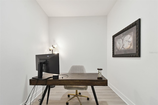 home office with light wood finished floors and baseboards