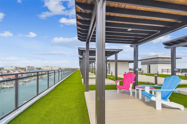 view of patio / terrace with a balcony and a water view