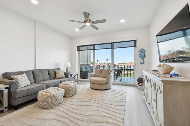 living area featuring recessed lighting, light wood-style flooring, and a ceiling fan