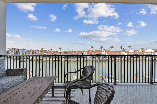 balcony featuring a residential view and a water view