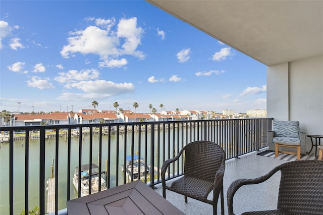 balcony with a residential view and a water view