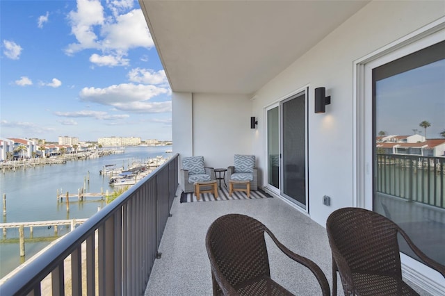 balcony featuring a sunroom and a water view