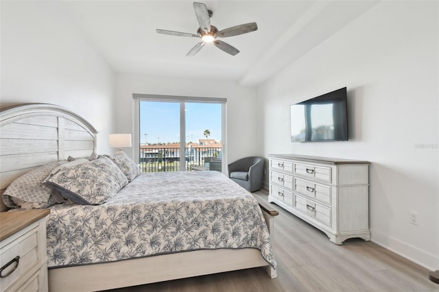 bedroom with baseboards, light wood finished floors, a ceiling fan, and access to outside