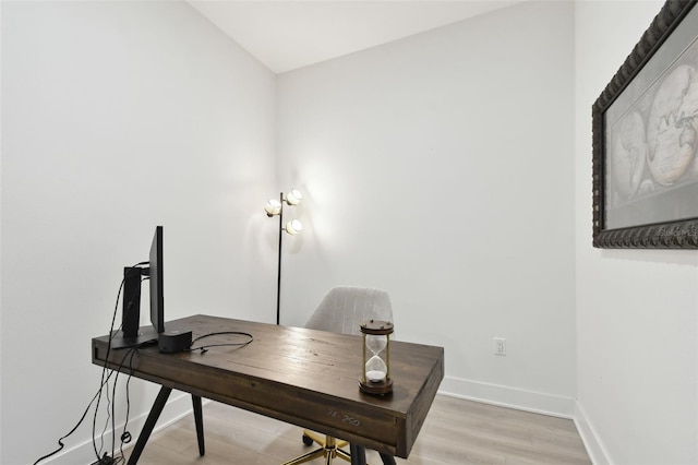 office area with light wood finished floors and baseboards