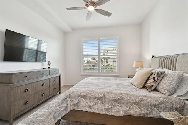 bedroom featuring baseboards, ceiling fan, and light wood finished floors