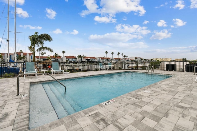 community pool featuring a patio and fence