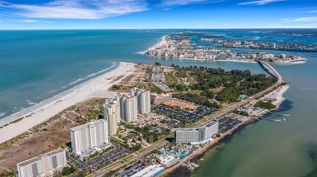 birds eye view of property featuring a beach view and a water view