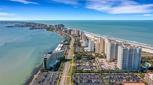 drone / aerial view featuring a water view and a view of the beach