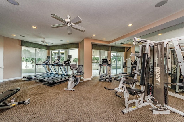 gym with a textured ceiling, ceiling fan, and carpet flooring