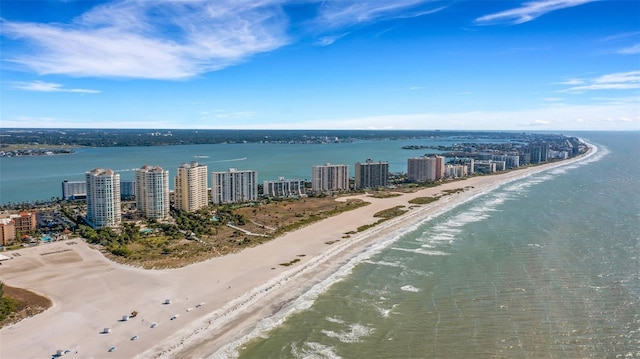 birds eye view of property with a water view and a view of the beach