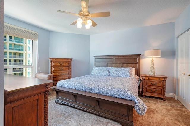 carpeted bedroom with a closet and ceiling fan