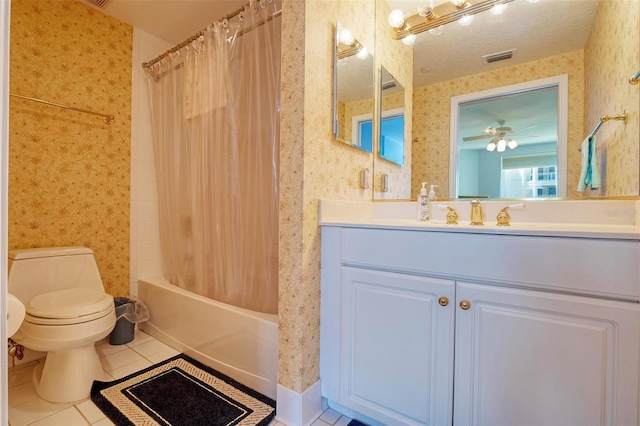 full bathroom featuring vanity with extensive cabinet space, shower / bath combo, tile floors, toilet, and ceiling fan