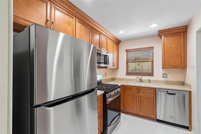 kitchen featuring sink, appliances with stainless steel finishes, and light tile flooring