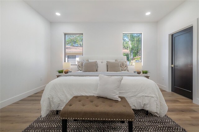 bedroom featuring light hardwood / wood-style floors and multiple windows