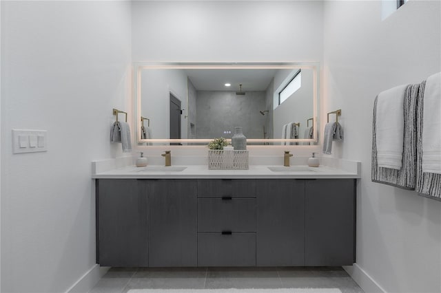 bathroom featuring tile patterned floors, a shower, and vanity