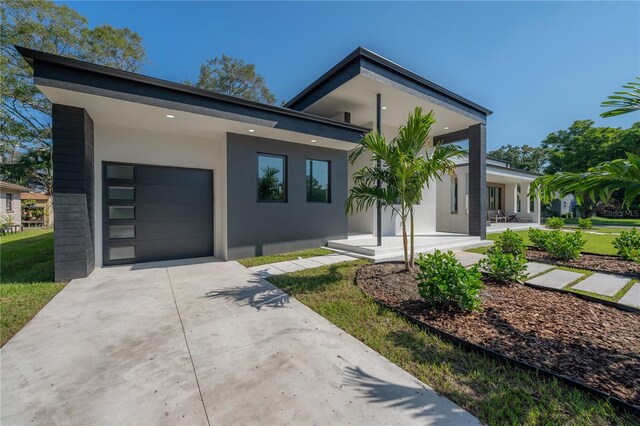 contemporary house featuring a porch and a garage