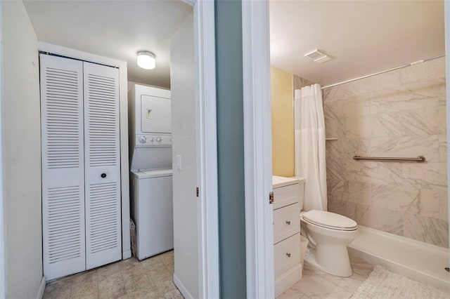 bathroom featuring toilet, tile floors, vanity, and stacked washer and clothes dryer