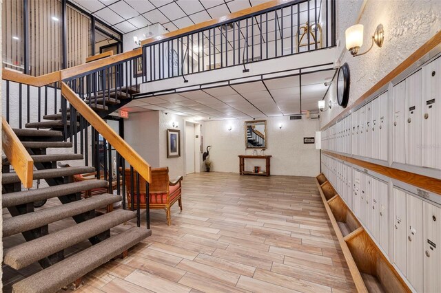 interior space featuring a high ceiling and light hardwood / wood-style flooring