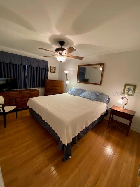 bedroom featuring wood-type flooring and ceiling fan