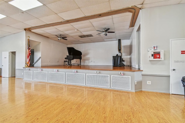 kitchen with ceiling fan, light wood-type flooring, and a paneled ceiling