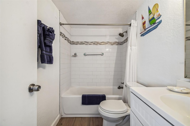 full bathroom with wood-type flooring, vanity, shower / tub combo, and toilet