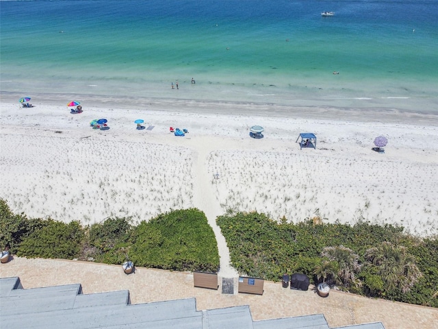 birds eye view of property with a view of the beach and a water view